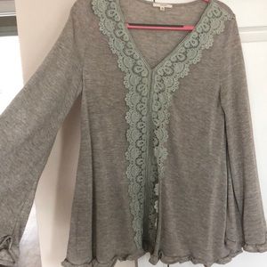 Gently worn top. lace detailing. ruffled sleeves.